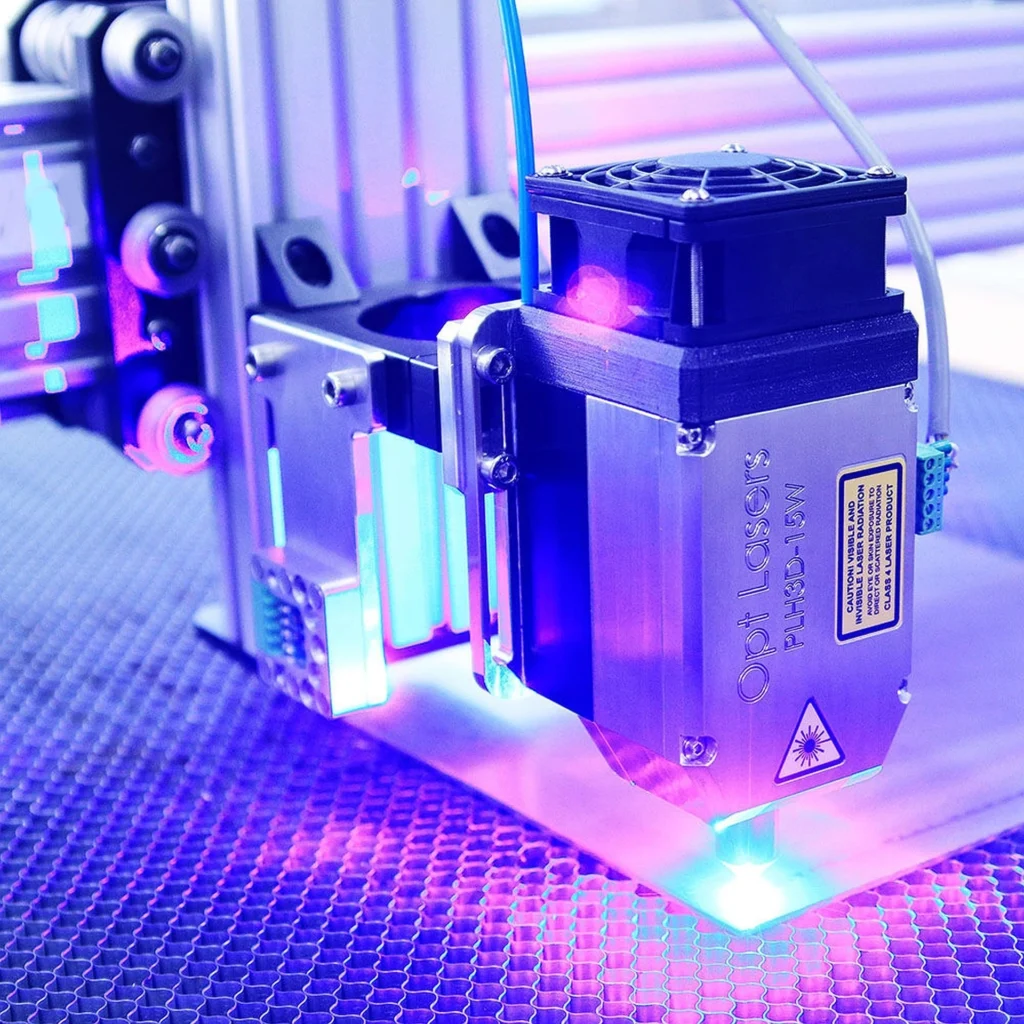 CNC milling epoxy resin machine head combining a router and laser attachment with safety glasses nearby