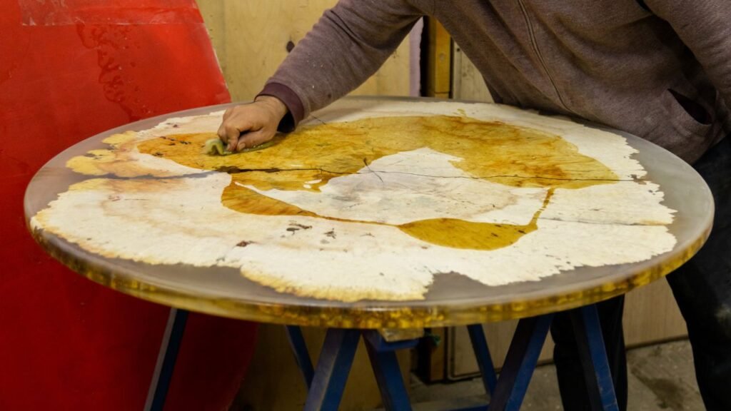 Finished round wood slab table with clear epoxy resin finish highlighting natural grain and live edge