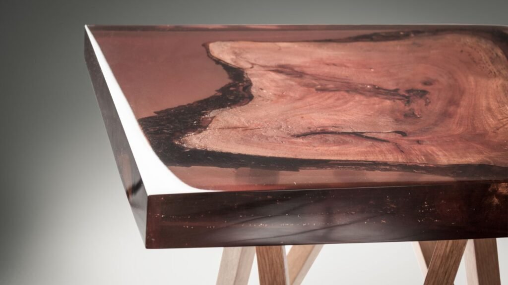 Close-up of gold flake epoxy resin swirled with natural stone and wood texture