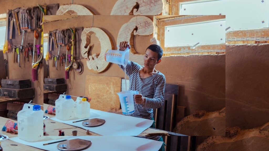 Woodworker measuring epoxy resin in a jug before pouring in a workshop