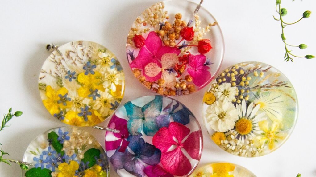 Colorful pressed flower resin coasters and pendants with botanical designs